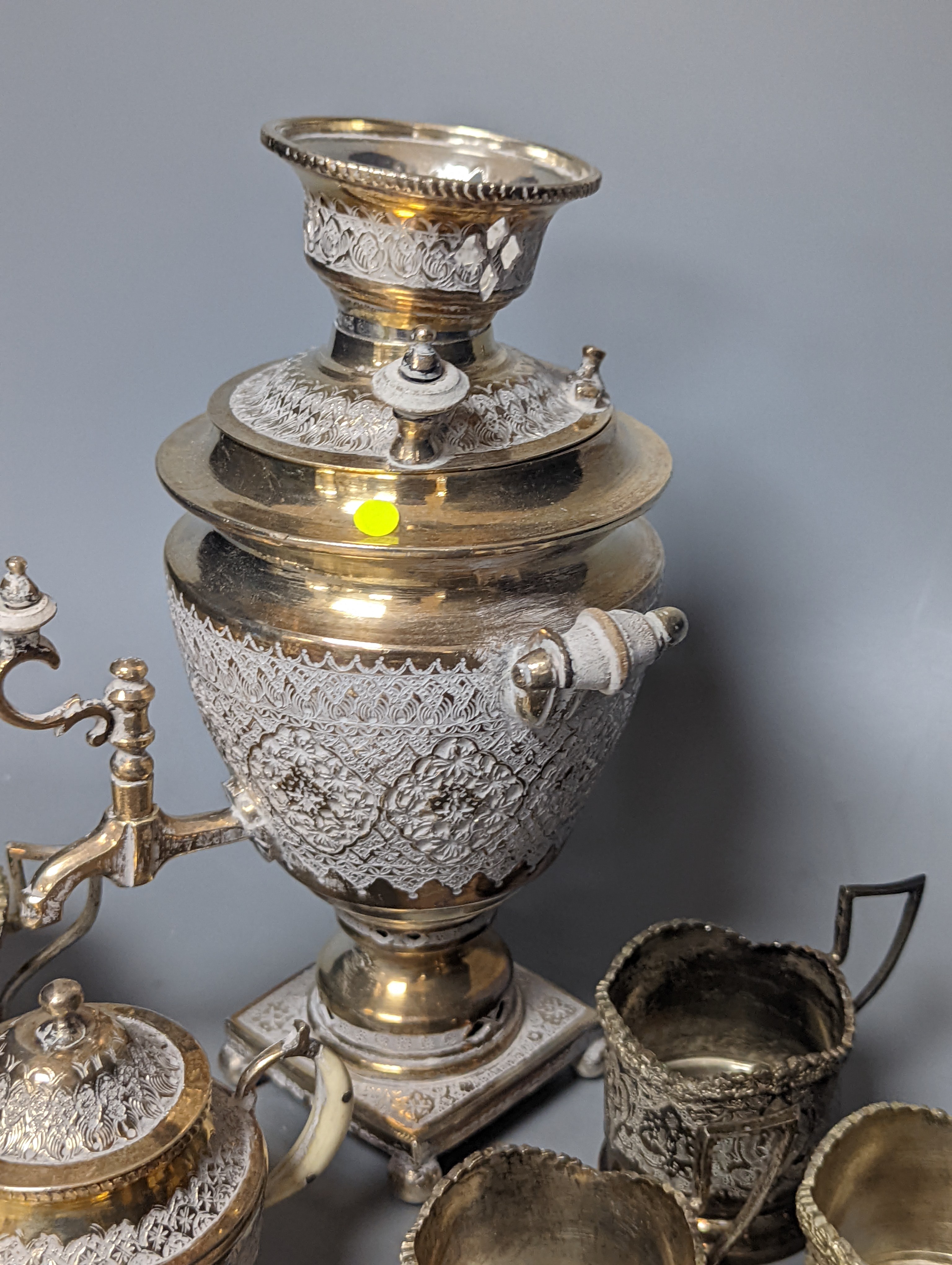 A set of six Persian embossed 84 standard white metal coffee cup holders and matching sugar bowl and cover by Vartan and four other Persian white metal items.